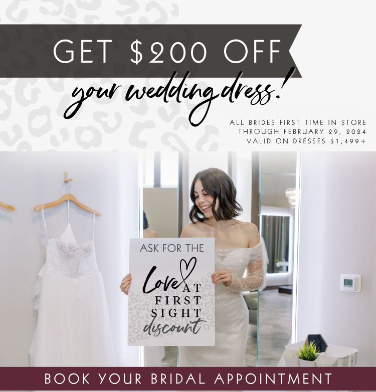 Save $200 on your wedding dress through Feb 29, 24. Bride in long sleeve sparkle Sincerity gown standing in well lit bridal suite