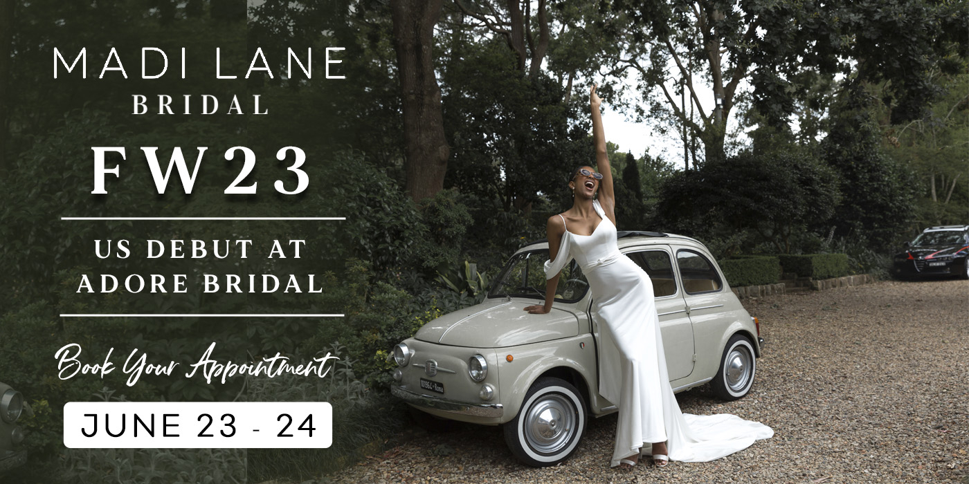 Bride by vintage Italian car in sleek simple wedding gown